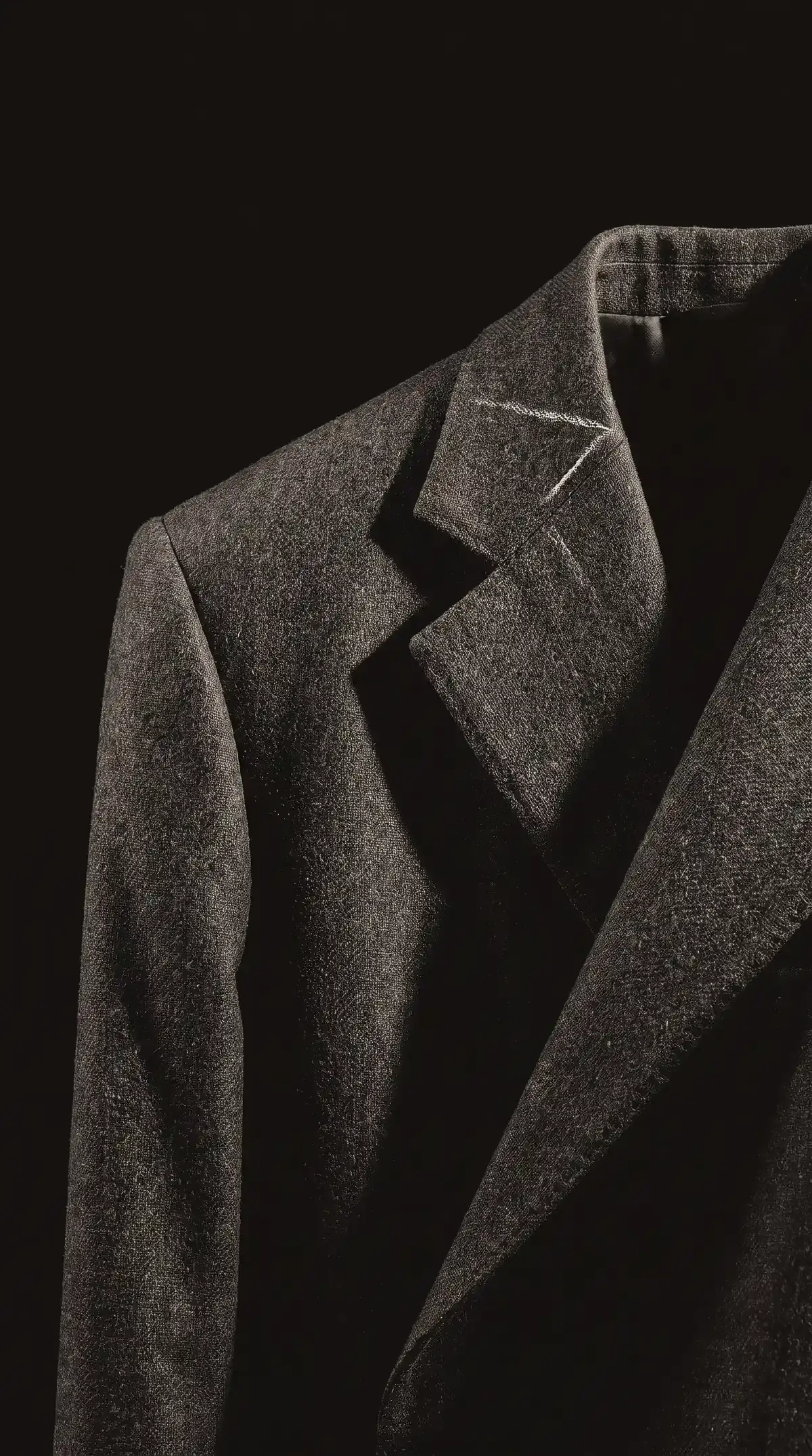 Tailored jacket in charcoal wool gabardine on a dress form