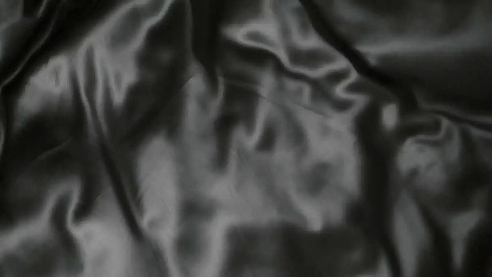 Black silk moving under a single light
